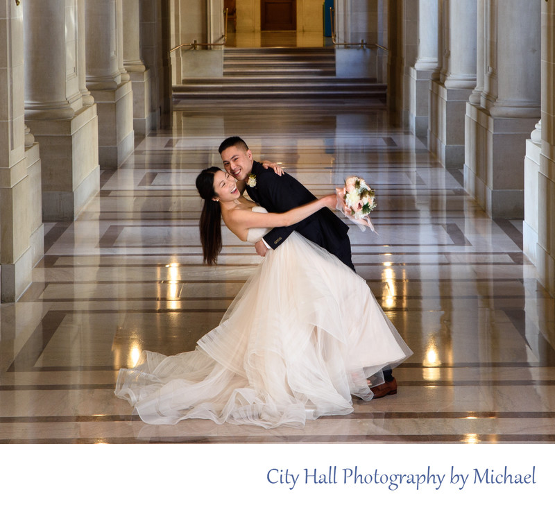 Asian couple laughing while posing at San Francisco city hall