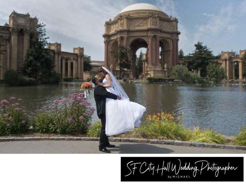 Grooms lifts bride at Palace of Fine Arts in San Francisco