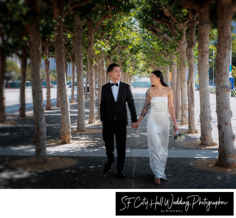 Newly married couple walking in Civic Center Park in San Francisco