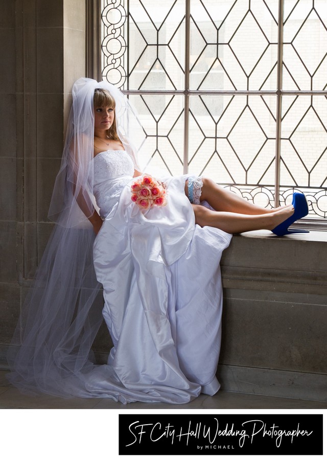 Gorgeous bride sitting in the 3rd floor window at SF City Hall