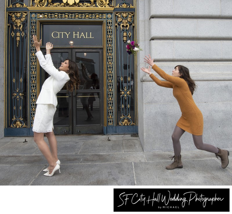 San Francisco city hall bride throws her bouquet to maid of honor