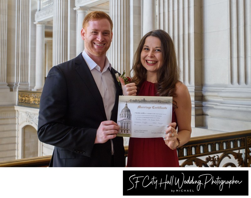 City Hall newlyweds displaying their marriage license