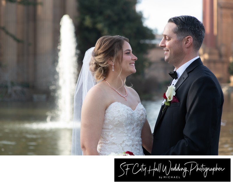 Newlyweds smiling at San Francisco's famed Palace of Fine Arts