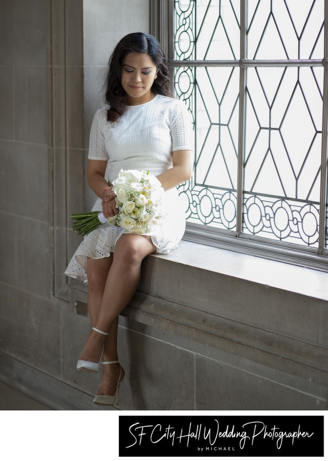 Wedding photographer at City Hall - bride contemplating her bouquet