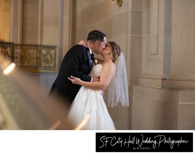 City hall wedding photographer image of groom kissing bride