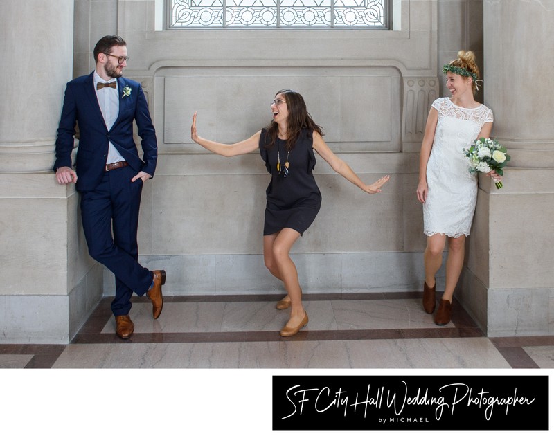 Friend having fun with bride and groom at San Francisco city hall