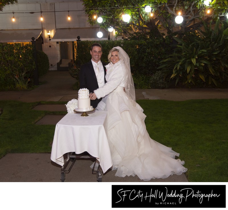 Elegant bride and groom cutting their wedding cake outdoors in San Francisco