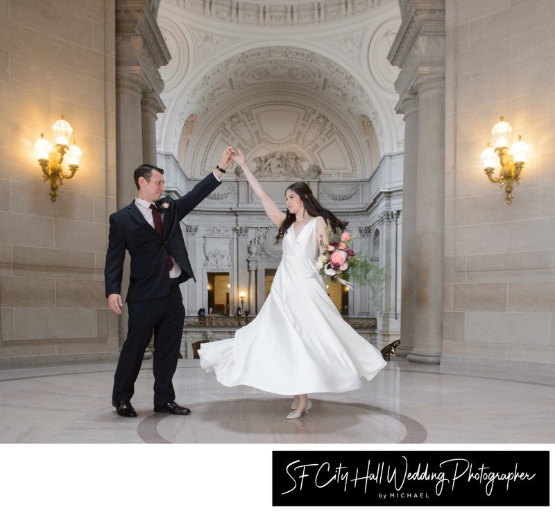 Groom spinning bride to show how big the gown is