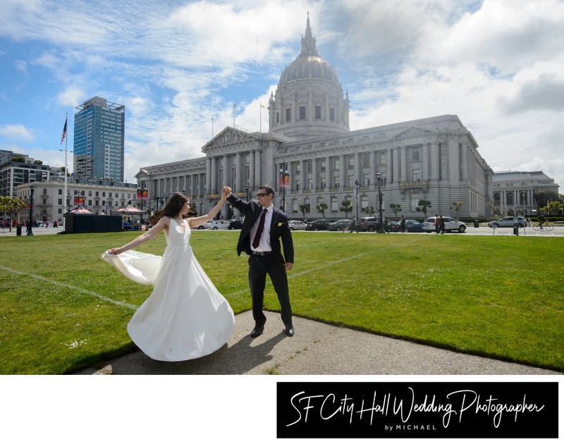 Groom spinning bride outside of San Francisco city hall