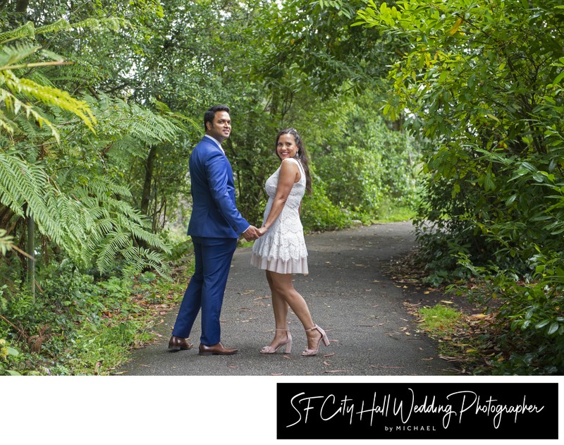 Newlyweds walking for the path near Stow Lake for wedding pictures
