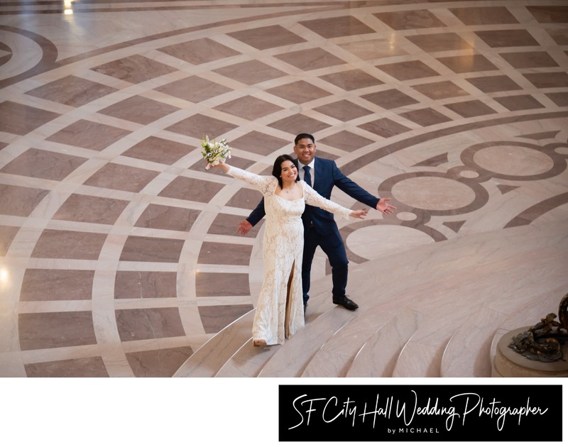 Fun City Hall wedding couple celebrating on the Grand Staircase