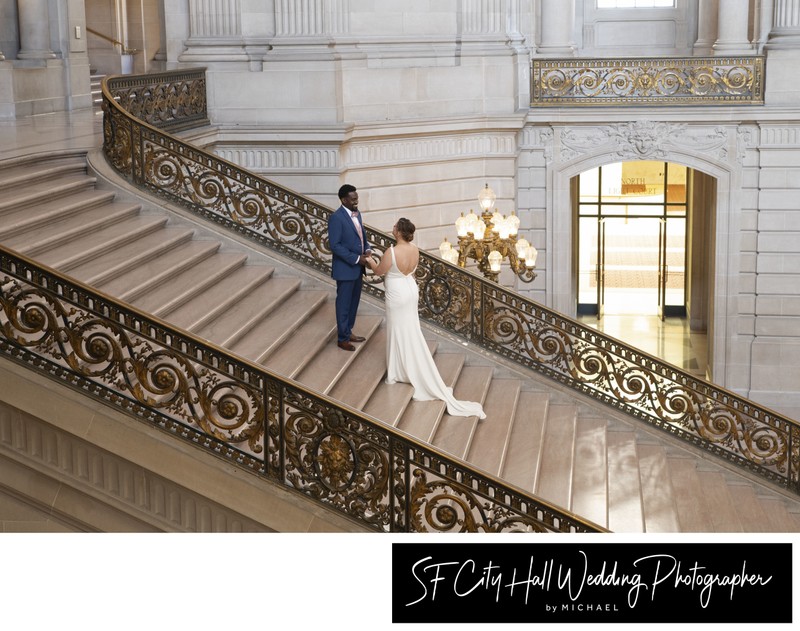 Far away wedding photography of newlyweds on the Grand Staircase at San Francisco city hall