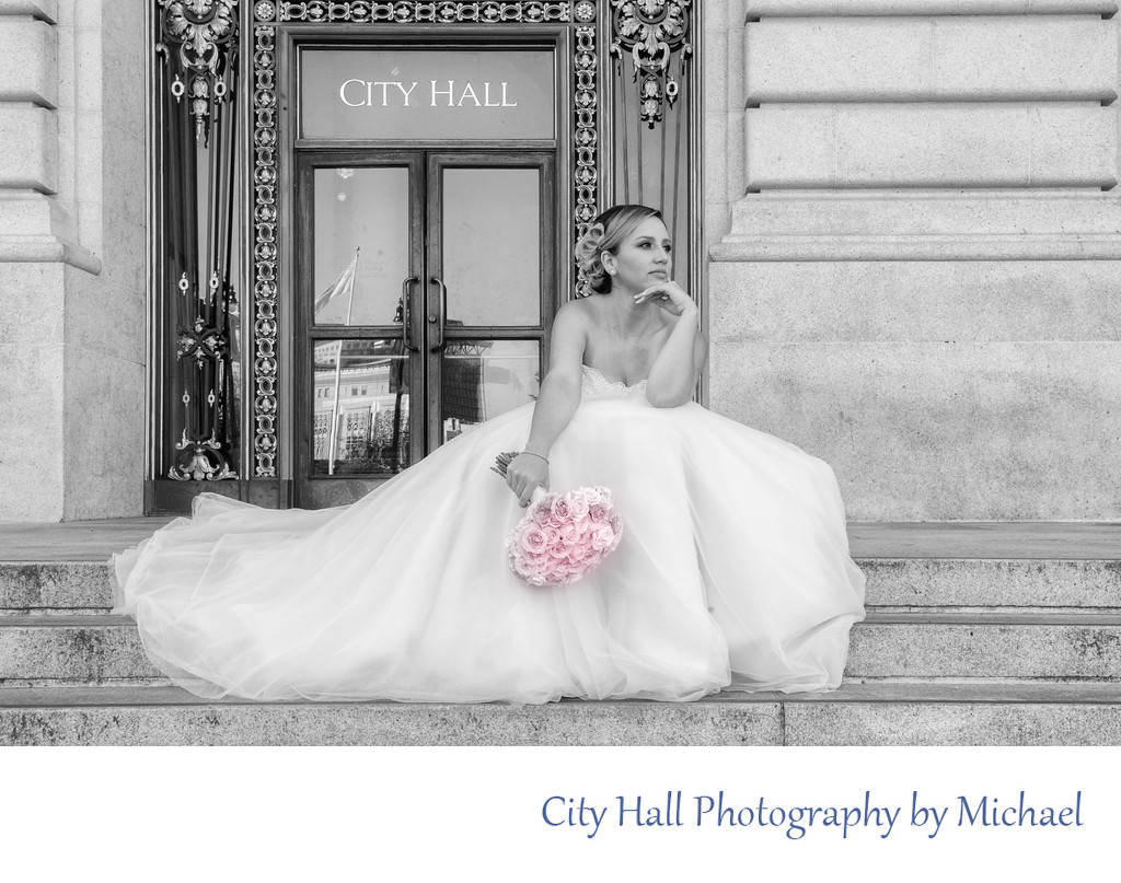 San Francisco city hall wedding photographer - Bride sitting on the steps Looking out in the distance