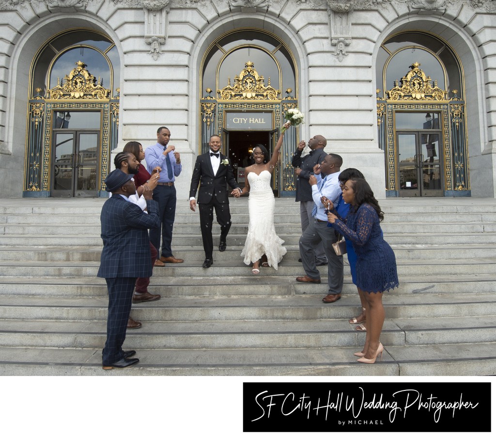 Blowing bubbles at bride and groom leaving SF City Hall