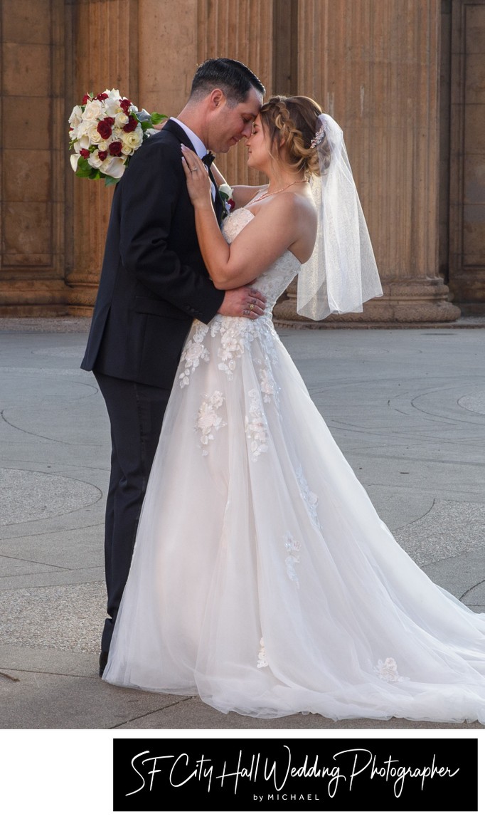 Groom bends the bride back slightly to reveal veil - wedding photography