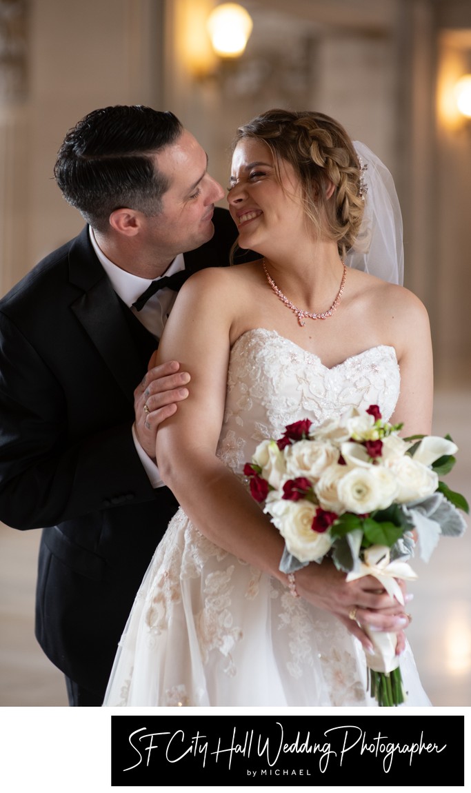 Groom makes bride giggle during SF City Hall photography session