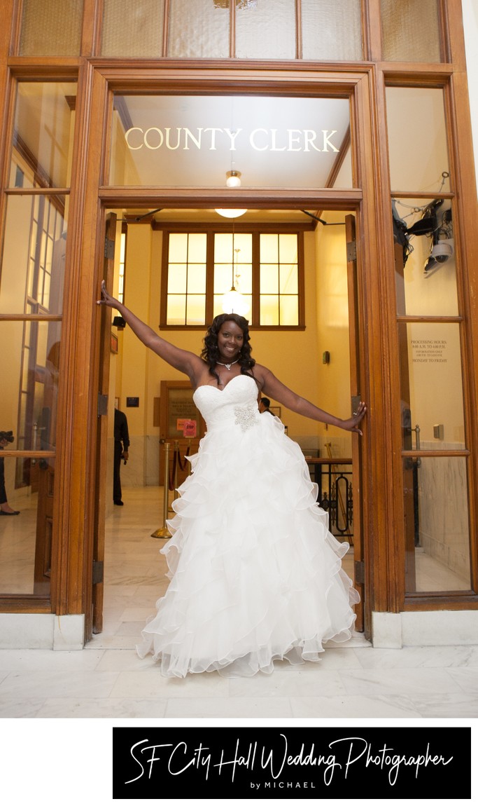 Bride posing in front of County Clerk's office at SF City Hall