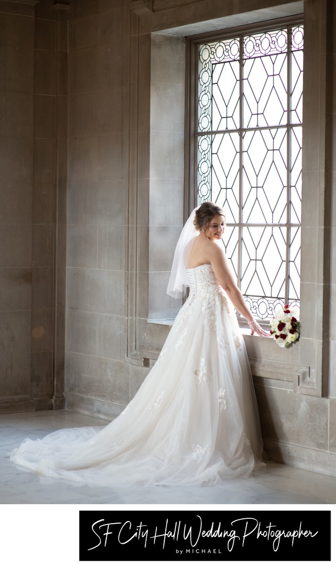 White wedding dress glowing in Window light in San Francisco