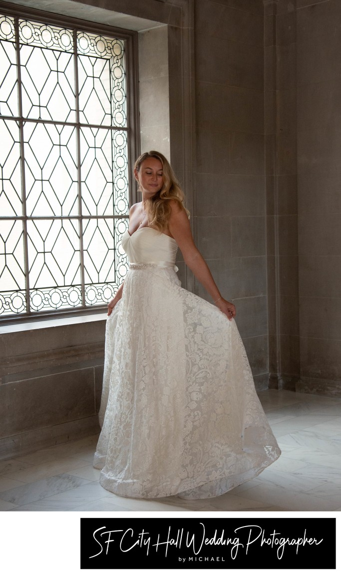 Beautiful SF City Hall bride displaying her wedding dress