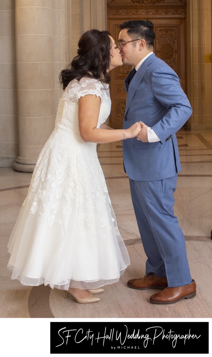 Happy couple kissing after city hall marriage in San Francisco