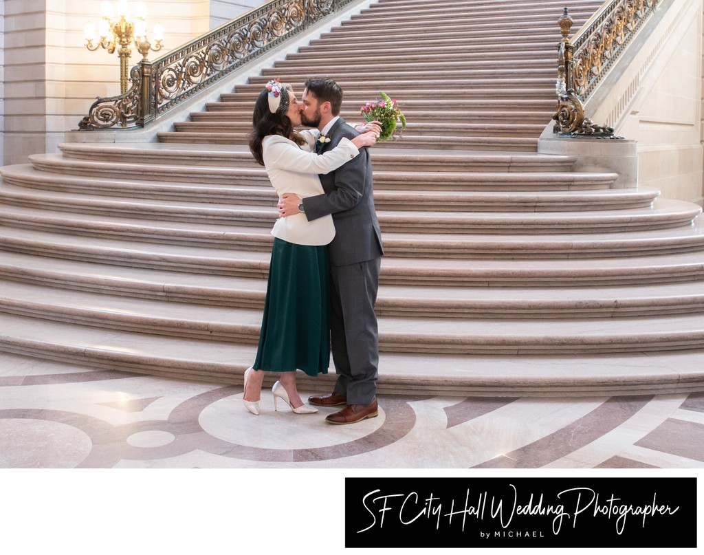 Kissing at San Francisco city hall after wedding ceremony