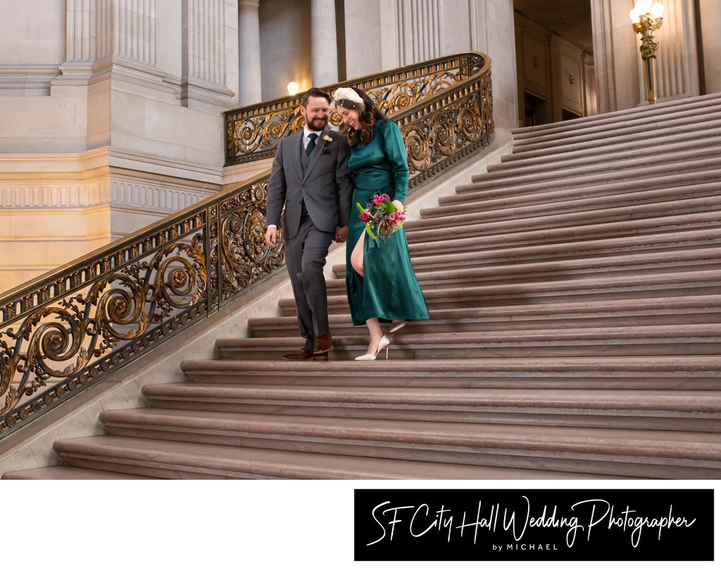 City Hall bride and groom share a laugh while descending grand staircase
