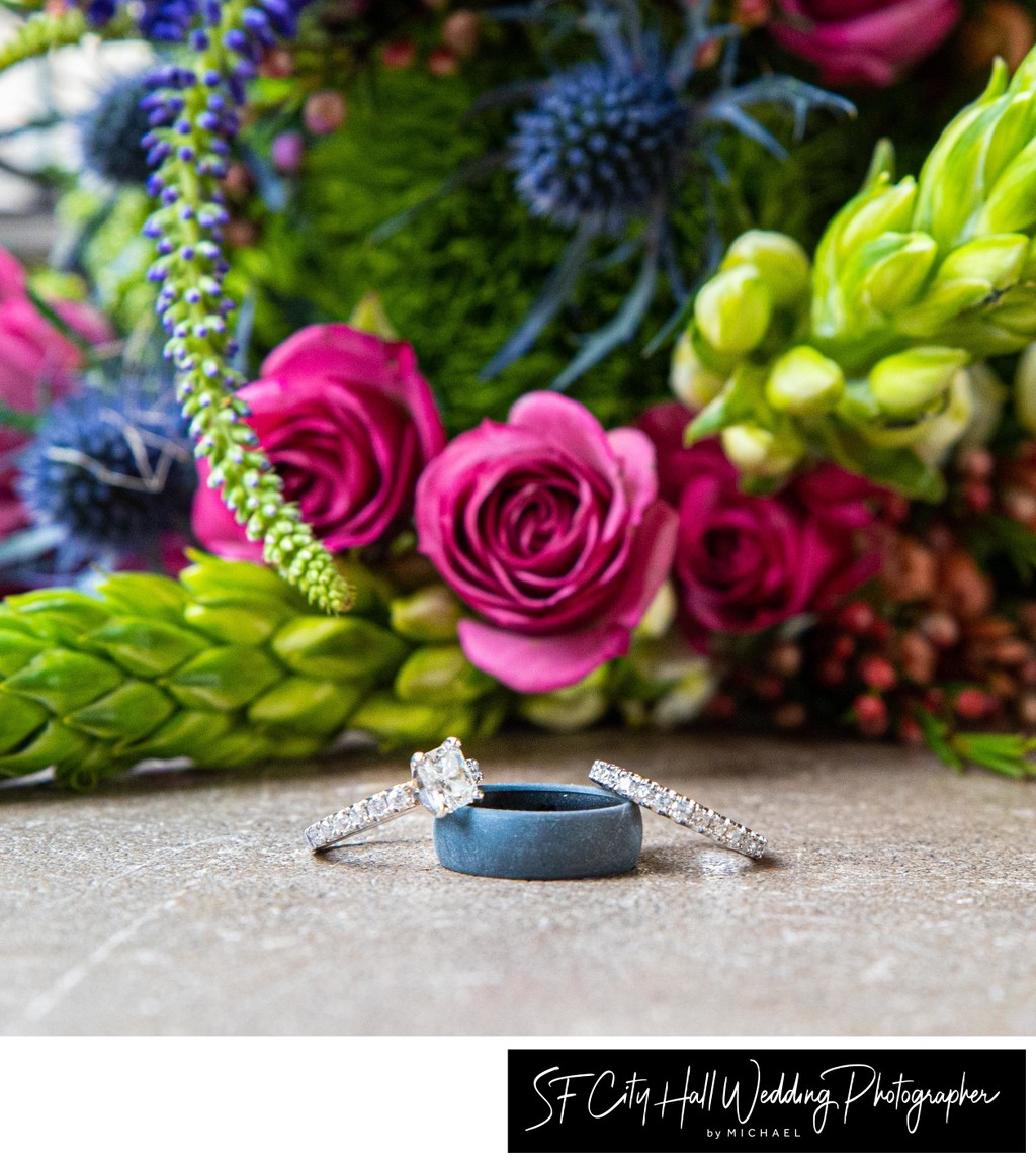 Still life photo of wedding rings and bouquet