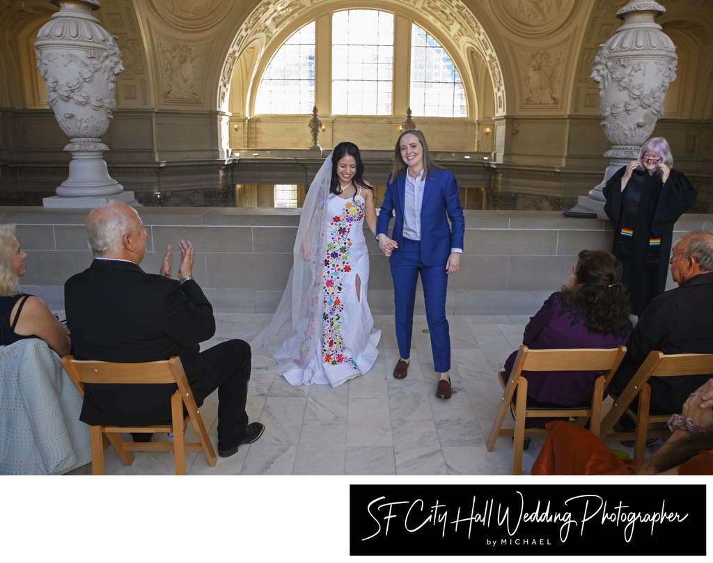 The Happy Couple walking down the aisle at SF City Hall