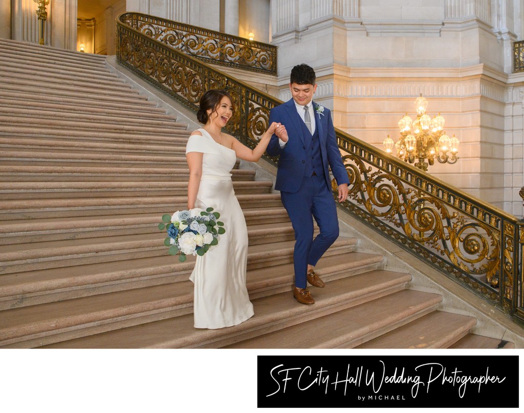 Filipino newlyweds having fun as they walk together down the Grand Staircase