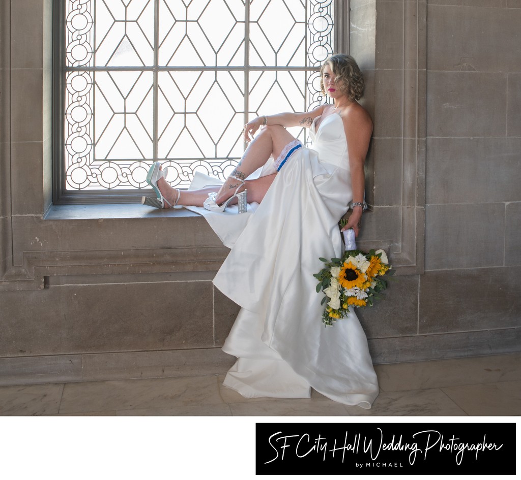 Gorgeous bride posing on 3rd floor window at SF City Hall