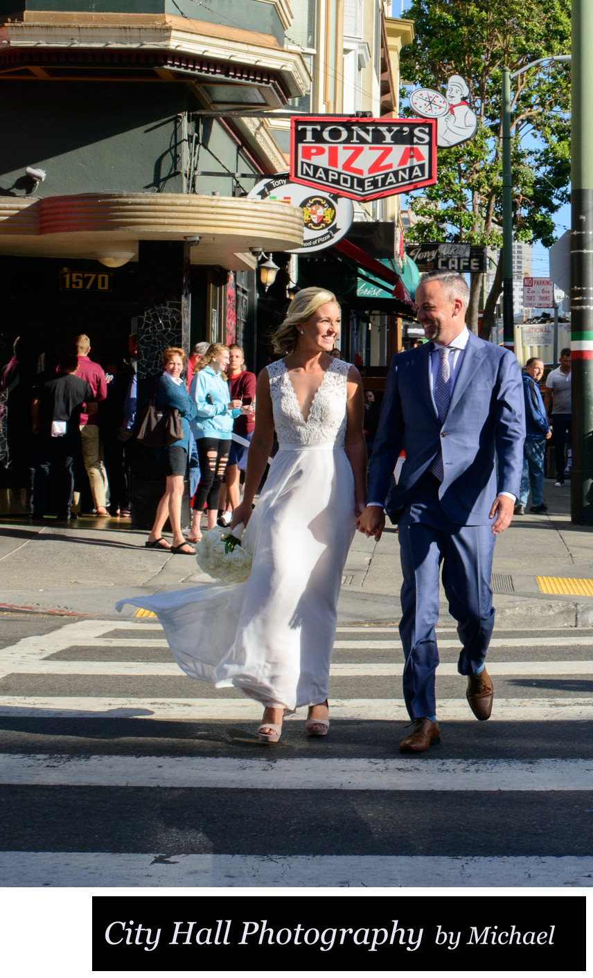 Recently Married couple walks by Tony's Pizza San Francisco