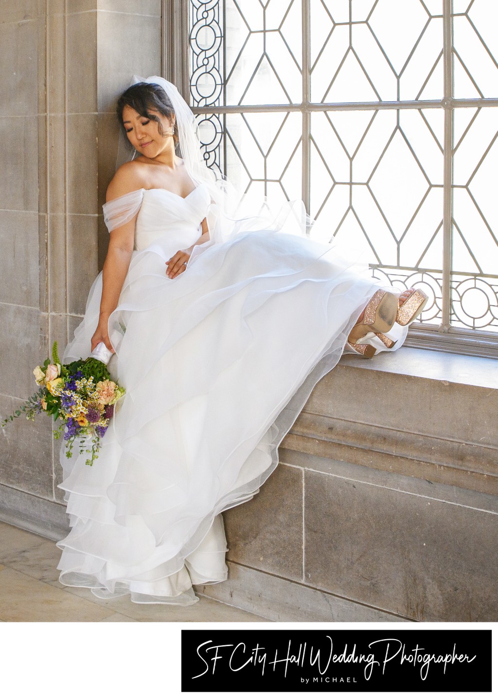 Beautiful Asian bride resting on the window sill at SF City Hall