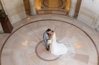Newly Married Bride and Groom kissing in the Rotunda at City Hall