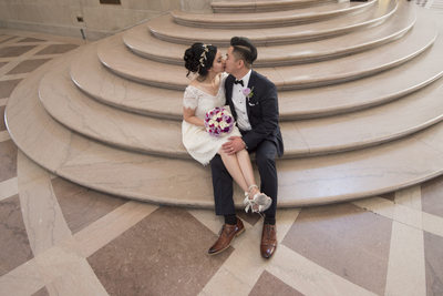 City Hall Grand Staircase kiss - San Francisco Wedding Photographer