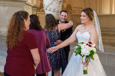Guests Congratulating Newlywed Bride and Groom at SF City Hall
