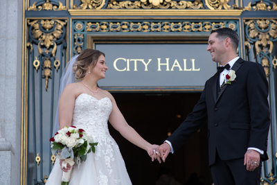 Newlyweds Leaving San Francisco City Hall by Entrance Sign