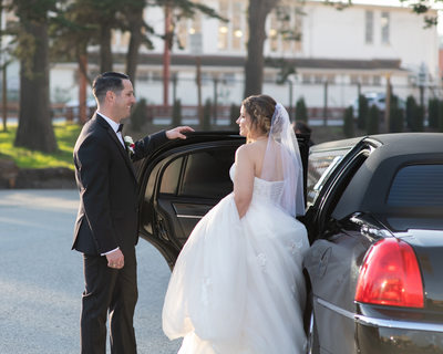 Groom helps his Bride into the Limousine at the Palace of Fine Arts.