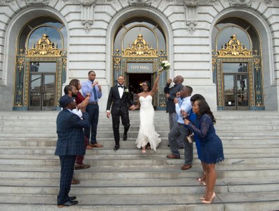 Blowing bubbles at bride and groom leaving SF City Hall