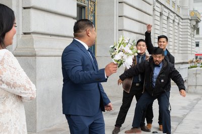Funny wedding picture with Groom throwing the Bouquet