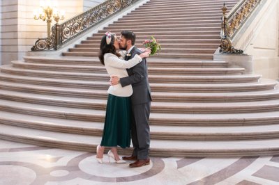 Kissing at San Francisco city hall after wedding ceremony
