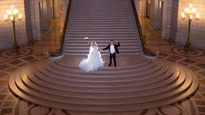 Newlyweds celebrating on the Grand Staircase at City Hall