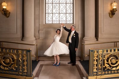 Groom twirling bride at San Francisco city hall