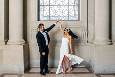 Groom Twirling Bride at SF City Hall - Wedding Photography