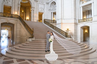 Brides veil floating in air on the Grand Staircase at SF City Hall