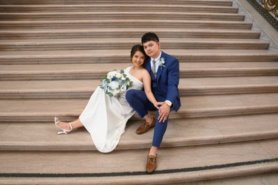 Bride and groom relaxing for wedding photography at SF City Hall