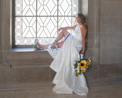 Gorgeous bride posing on 3rd floor window at SF City Hall