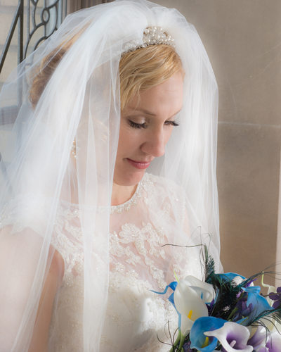 Bride Bouquet with face framed by veil in natural light
