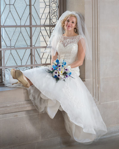 Cute Bridal Portrait Sitting on a City Hall window