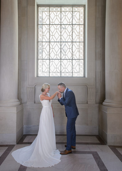 Hand kiss during wedding photography at city hall
