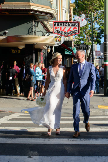 Recently Married couple walks by Tony's Pizza San Francisco